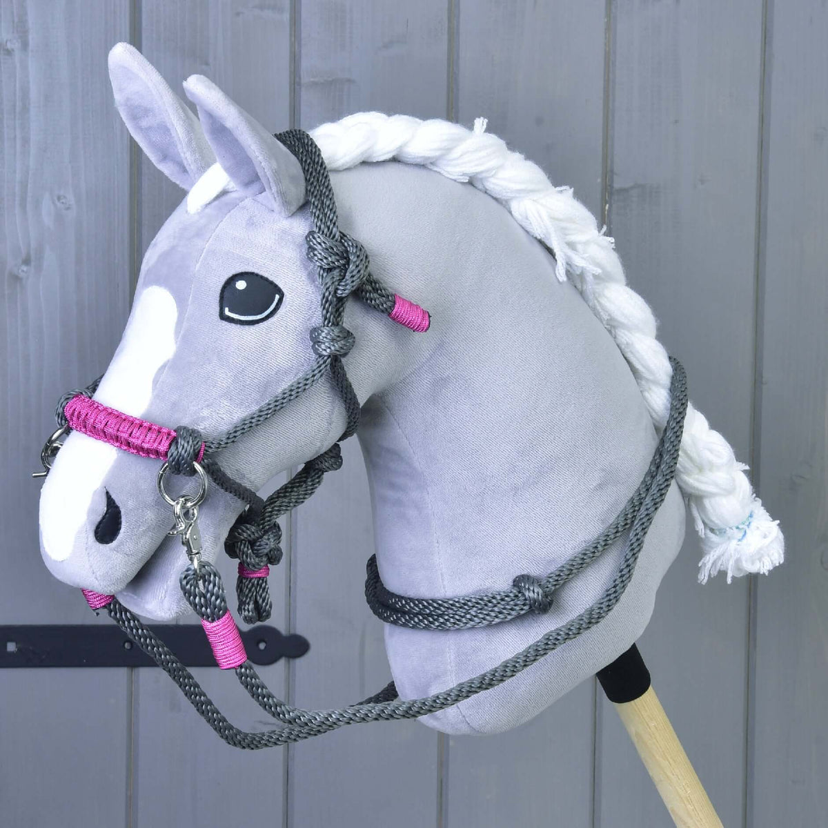 Grey Hobby Horse with braided white mane wearing the grey rope halter with pink noseband and grey rope reins