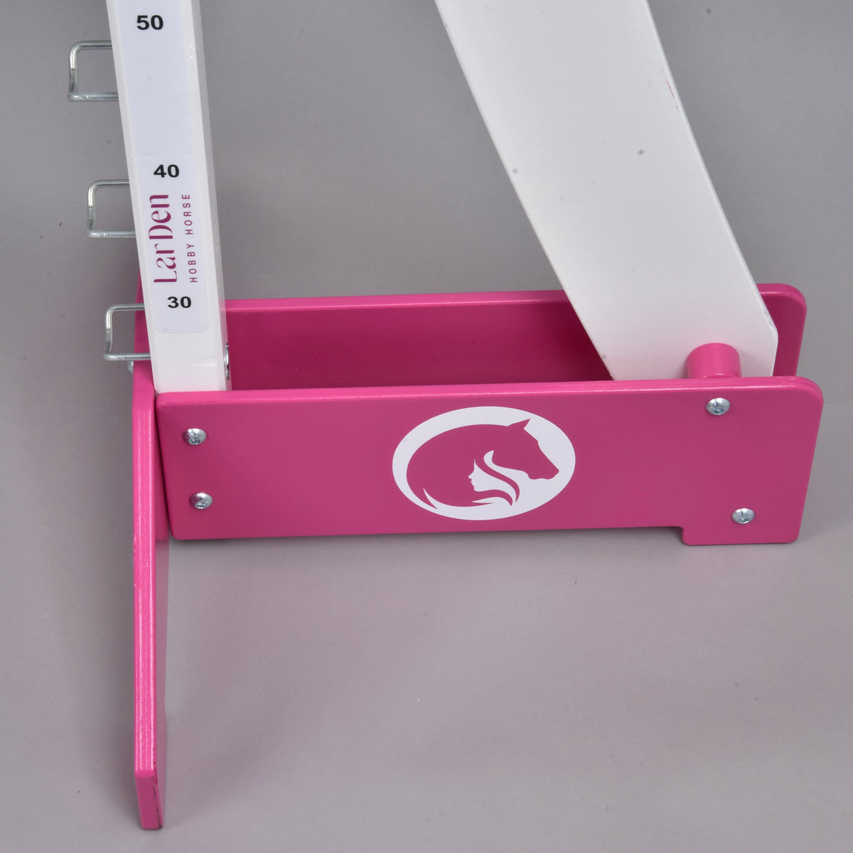 The second pink foot with a round white horse head and girl logo, the curved white wing rising behind it