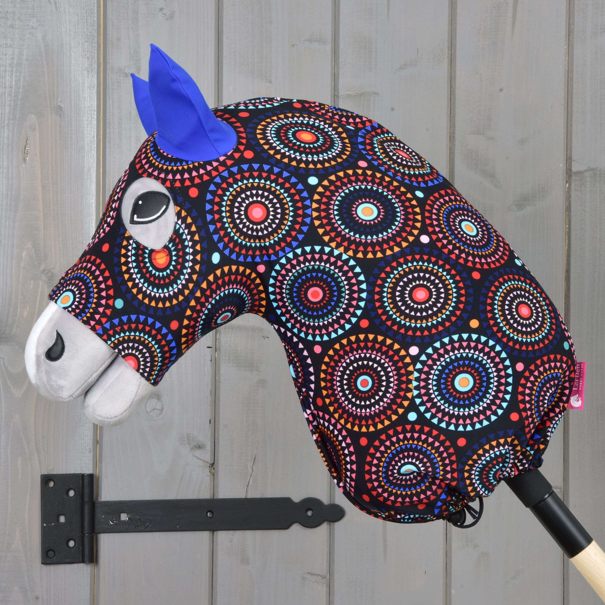 Siv Hobby Horse konj v zaščitni obleki Alice od strani, pisan potisk z mandalami je pri palici zategnjen z vrvico