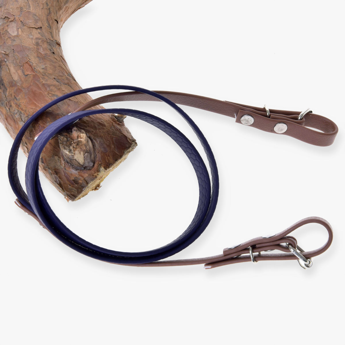 Hobby Horse Reins rubberized brown purple by LarDen, dark purple middle and brown buckle ends, looped over a branch