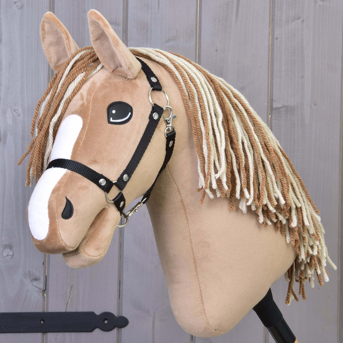 Hobby Horse Bren with Black Halter by LarDen, a tan plush head with a white blaze and brown and cream yarn mane