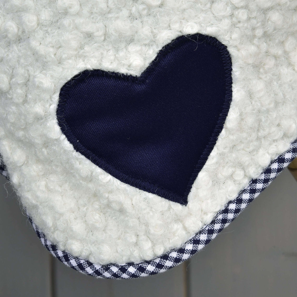 Close-up of the navy heart patch with zigzag stitching on the Hobby Horse Blanket cube blue