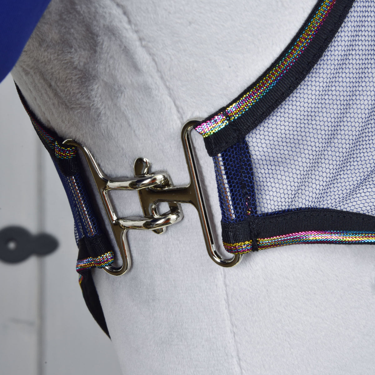 Close-up of the Set Fly Combo chest closure: a silver metal clasp joining the mesh fly sheet with rainbow-striped binding