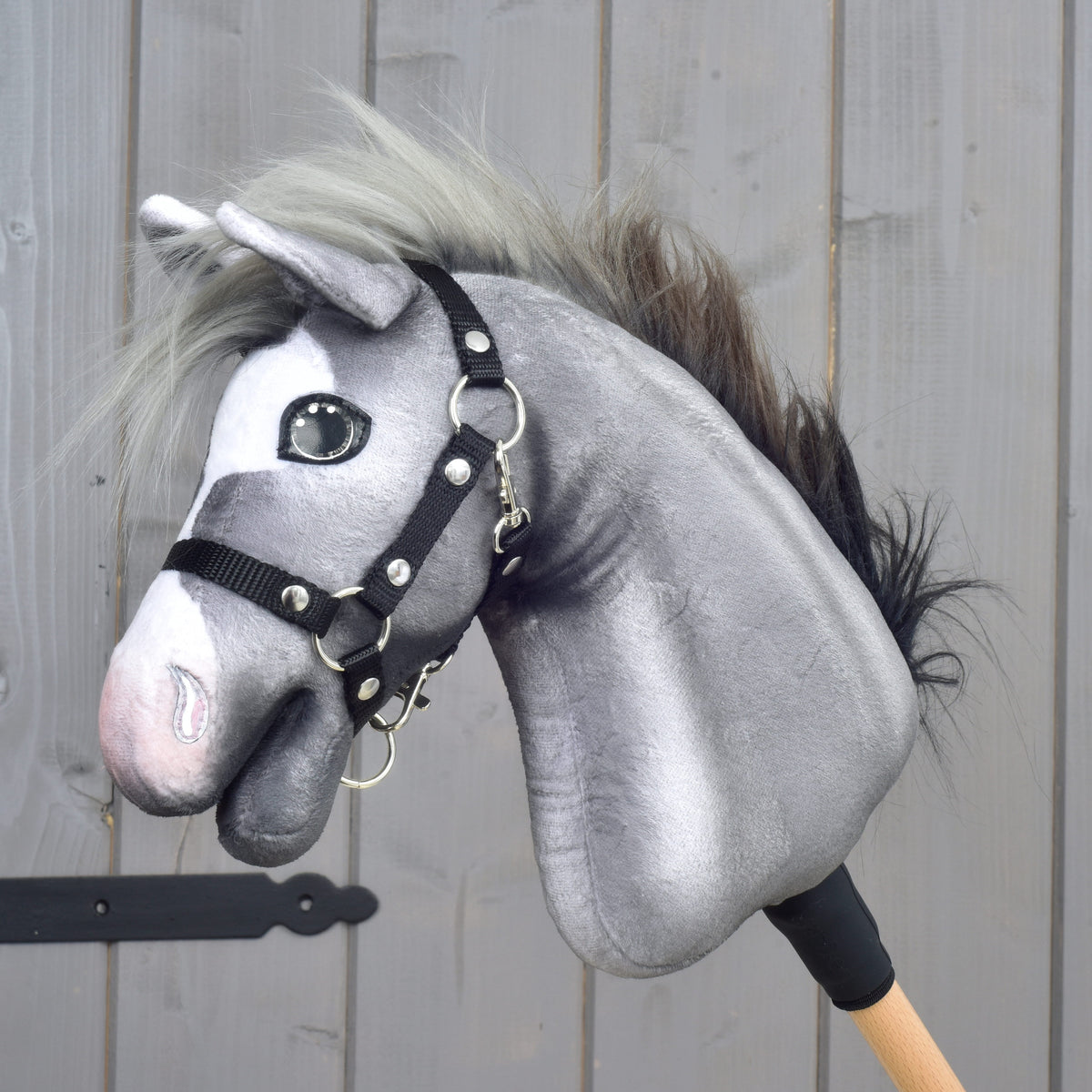 LarDen Hobby Horse Flint, a grey plush horse with a light grey and black mane wearing a black halter
