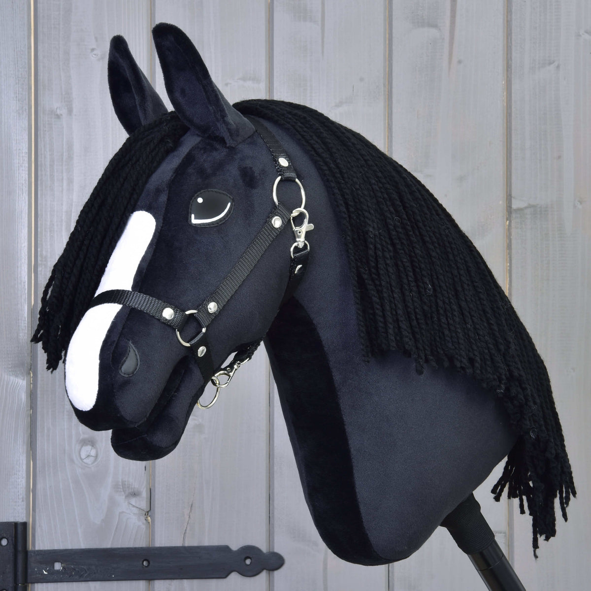 Hobby Horse Freya with Black Halter by LarDen, a black plush head with a white blaze and a long black yarn mane