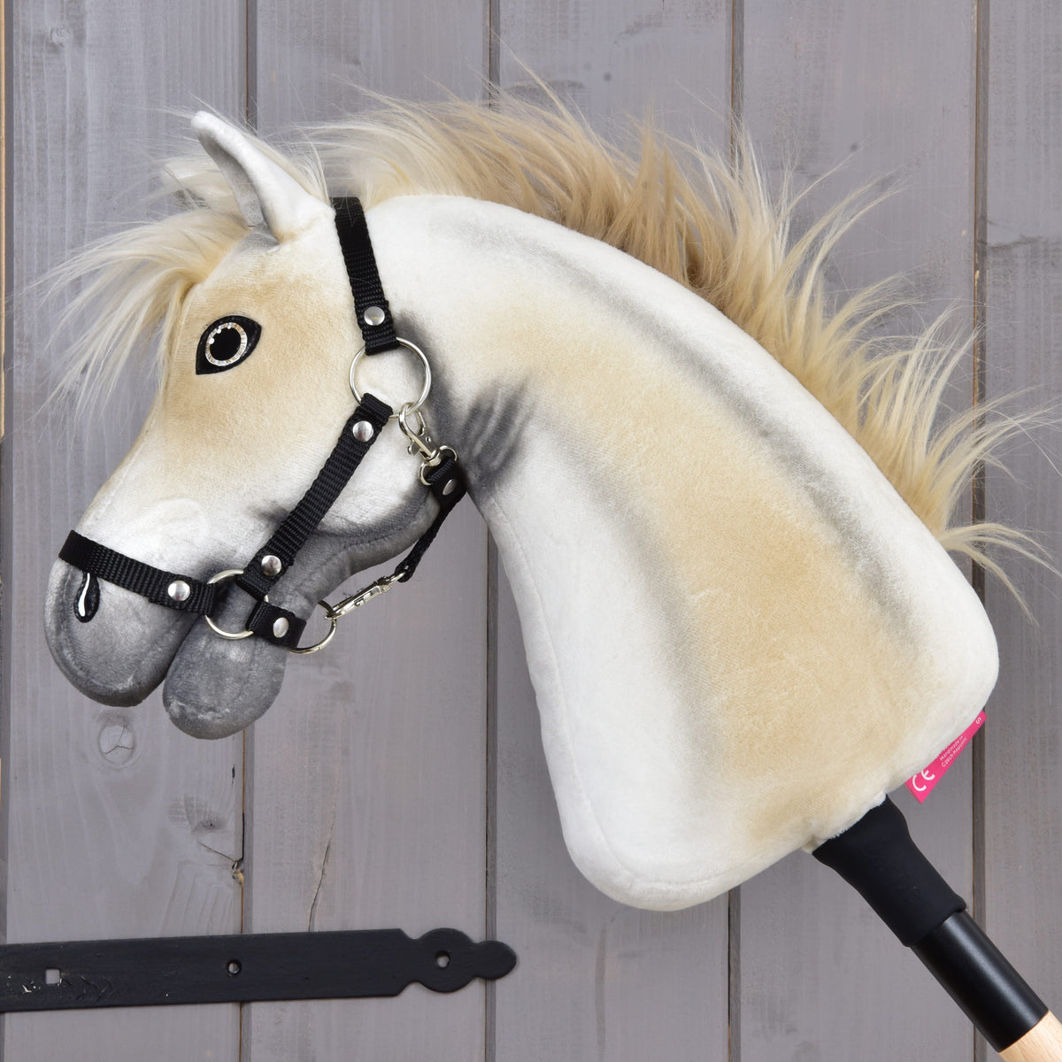 Hobby Horse Honey Pearl from the side with golden shading on the white neck and a long, flowing blond mane