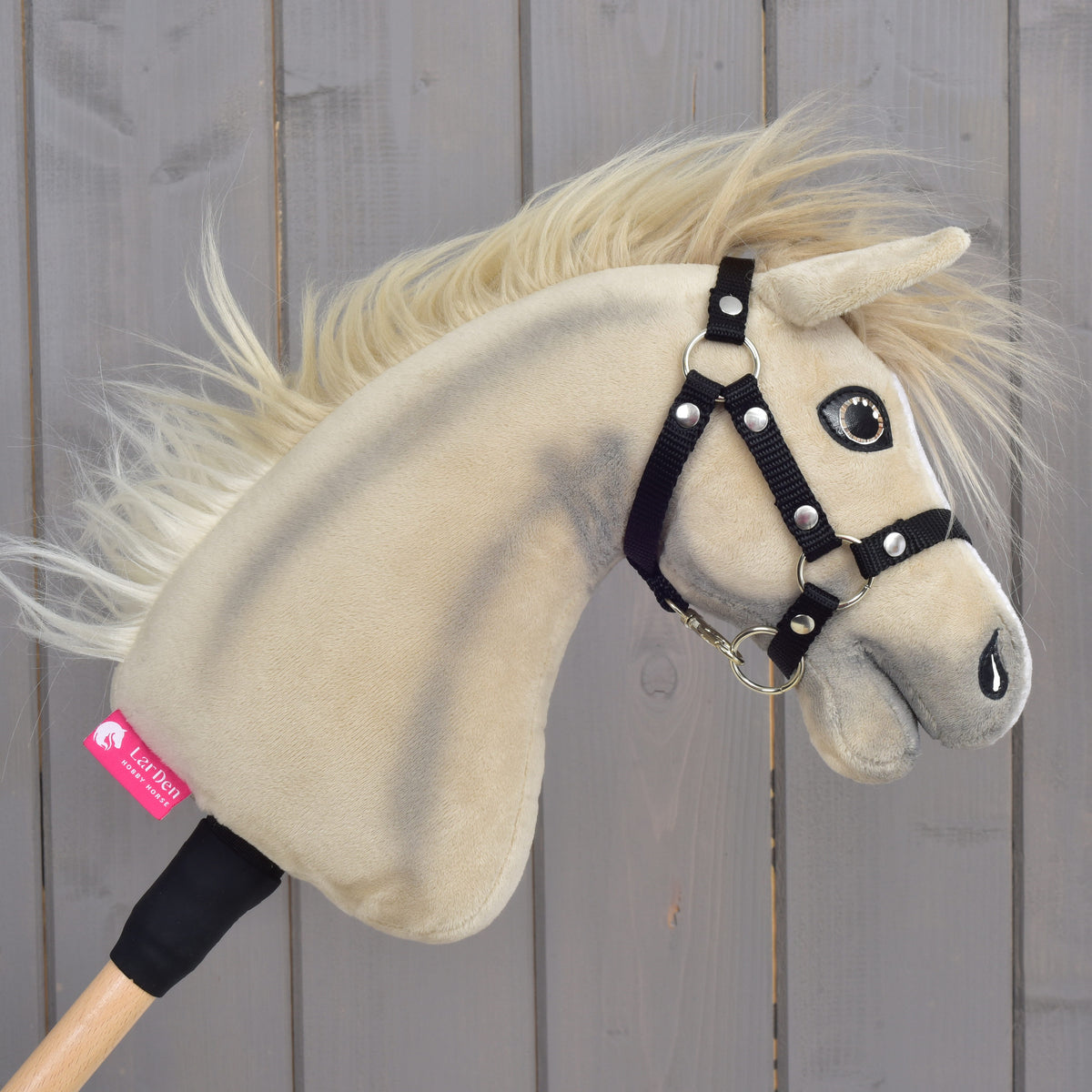 Hobby Horse Ivory Dream facing right with the pink LarDen label on the neck and the blond mane blowing back