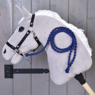 Grey Hobby Horse with white mane and black halter, the royal blue braided lead rope clipped on and coiled over its neck