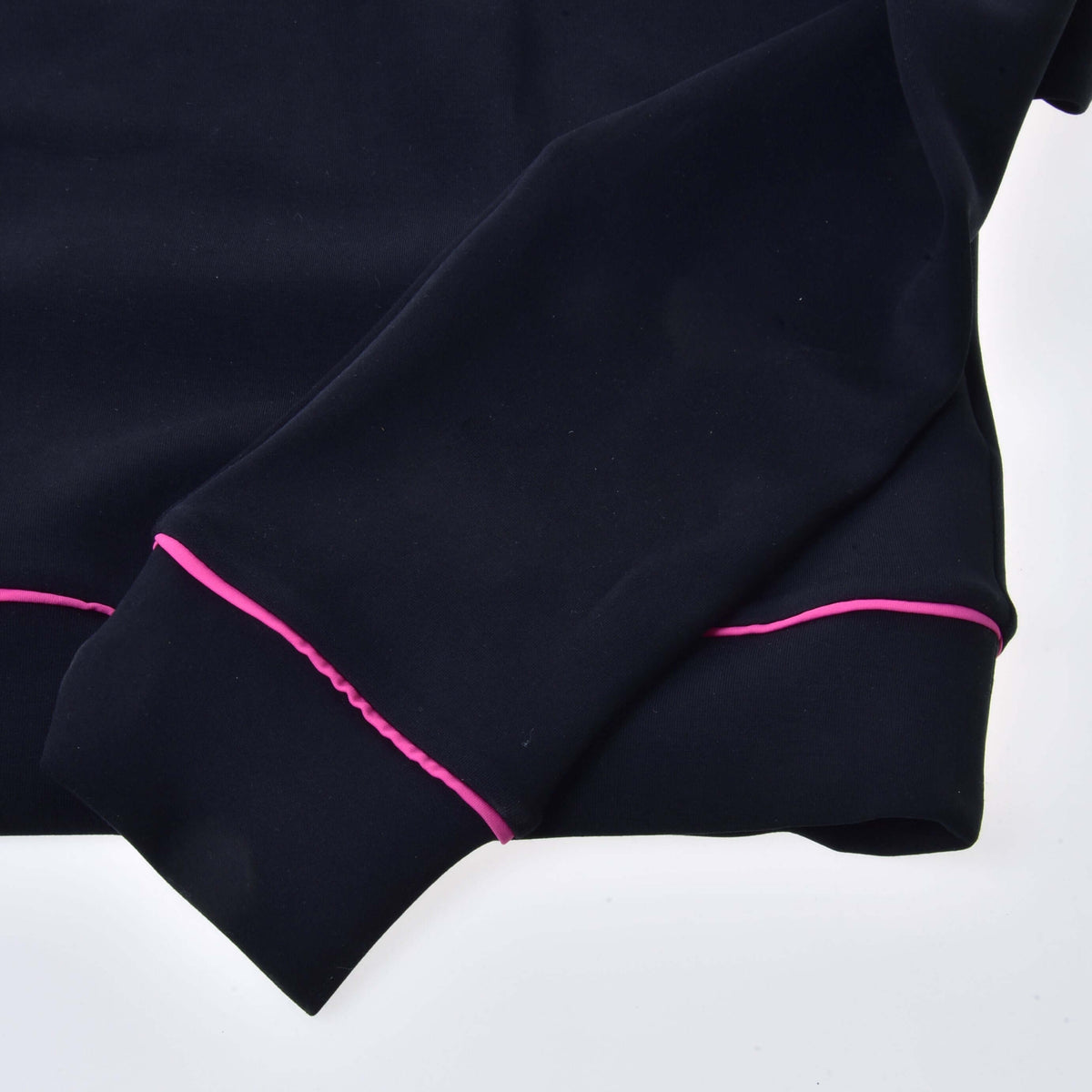 Close-up of a black cuff and hem with thin pink piping on the Hobby Horse sweatshirt