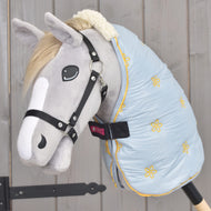Grey Hobby Horse in a black halter wearing the pale blue Stable Blanket Misty with yellow flowers and a cream collar