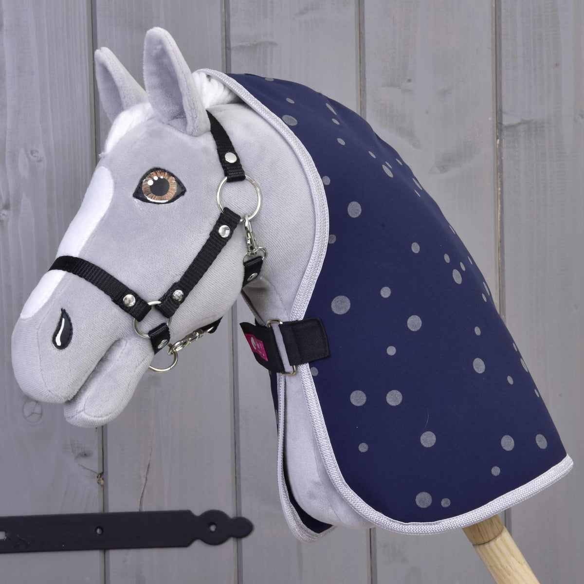 Grey plush Hobby Horse wearing the navy dotted Stable Blanket Night Sky with a black halter and chest strap