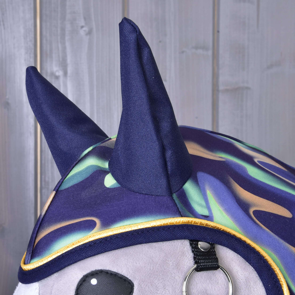 Close-up of the navy ear covers and wavy mint, lilac and beige print with yellow piping on the Hobby Horse Raincoat rainbow