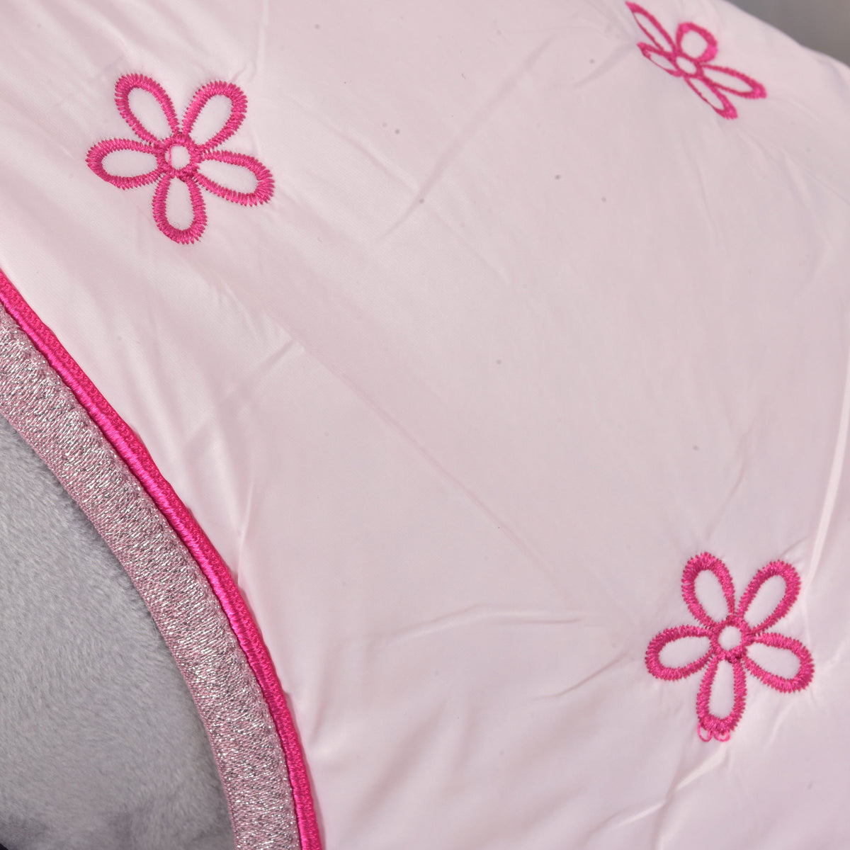Detail of the embroidered pink flowers, pink piping and sparkly trim on the pale pink Hobby Horse Stable Blanket Rosy
