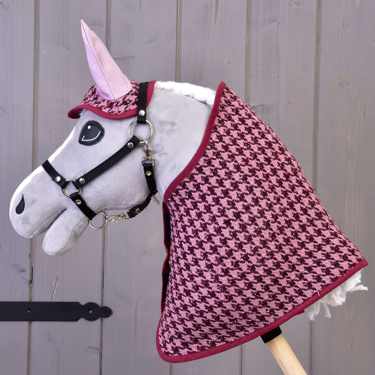 Grey Hobby Horse in a black halter wearing the complete Set festive Bordeaux, houndstooth blanket and ear bonnet