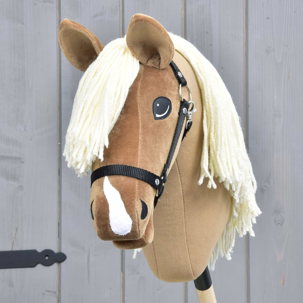 Hobby Horse konj Smart od spredaj s smetanastim čopom iz preje, temnejšim rjavim senčenjem na glavi in belo progo na nosu