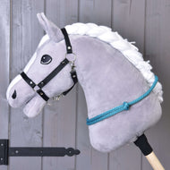 Grey Hobby Horse in a black webbing halter with the Cordeo Turquoise knotted around its neck