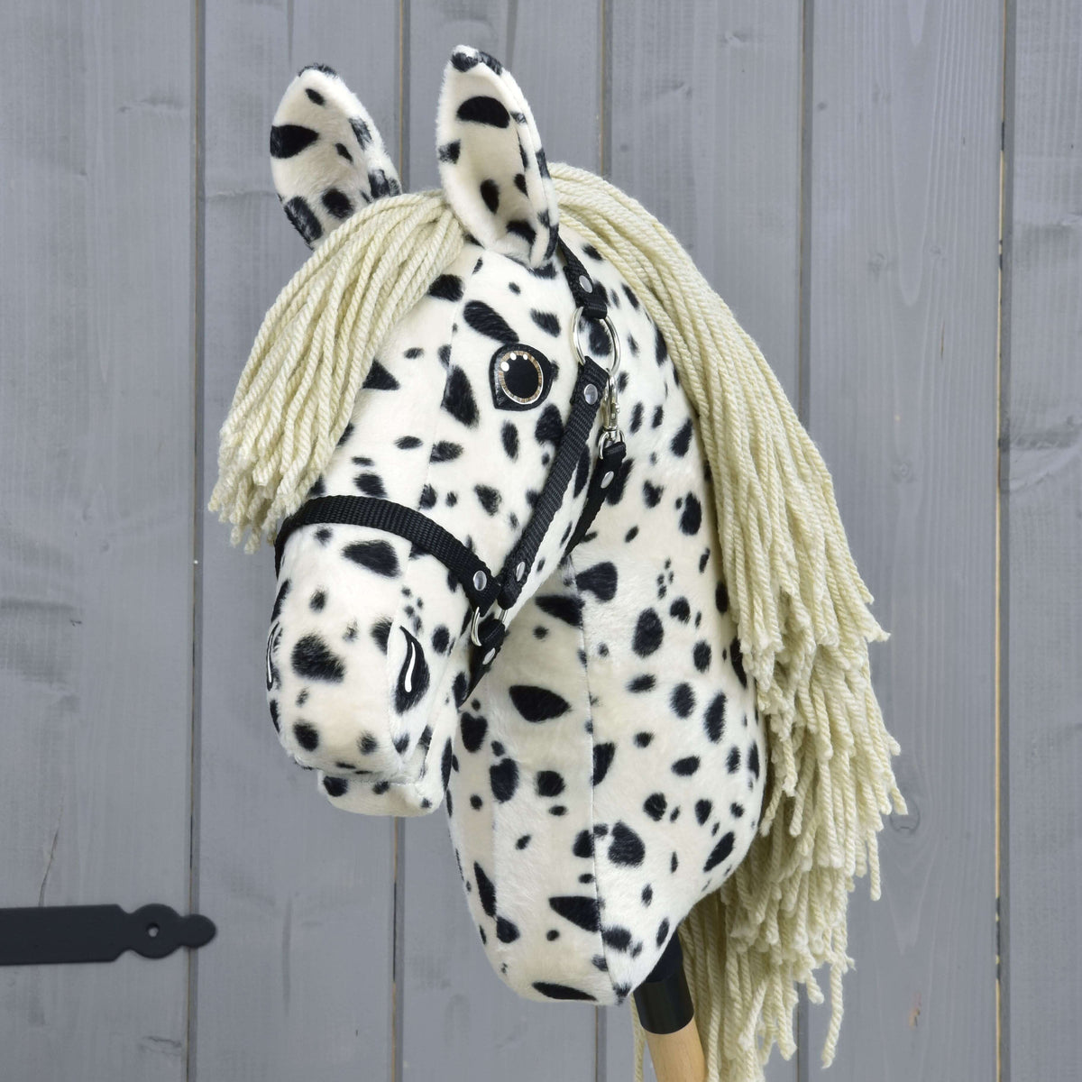 Front view of Hobby Horse Lord Valentine with spotted ears, a sand-coloured yarn forelock and silver-rimmed eyes