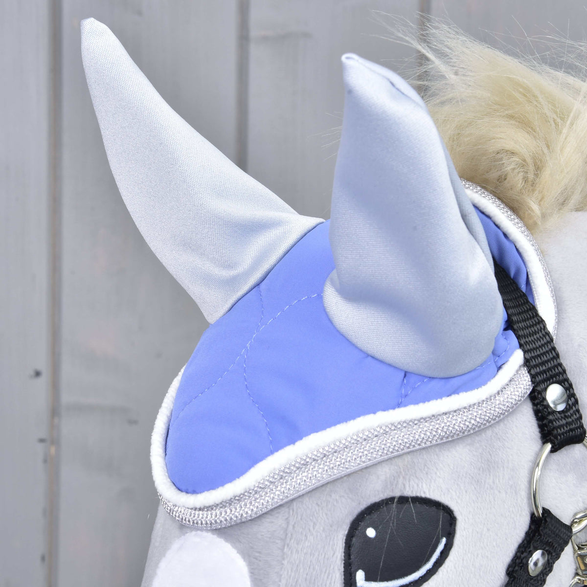 Close-up of the Ear Bonnet Light Violett on a grey Hobby Horse: soft quilting, light grey ears and a sparkly grey edge