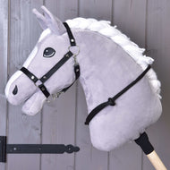 Grey Hobby Horse in a black webbing halter with the black rope cordeo around its neck