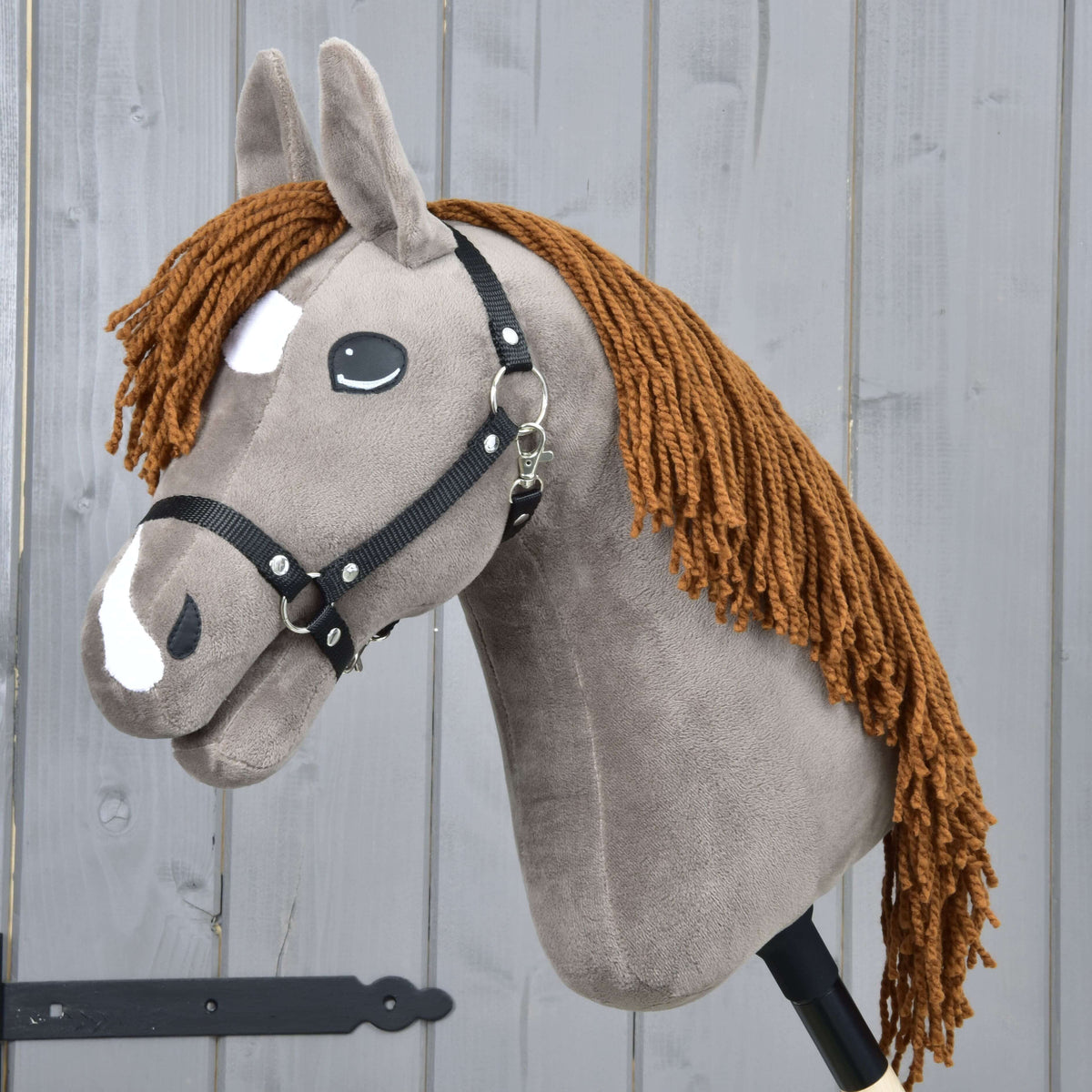 Hobby Horse Chanell with Black Halter by LarDen, a grey-brown plush head with a ginger yarn mane and white face markings