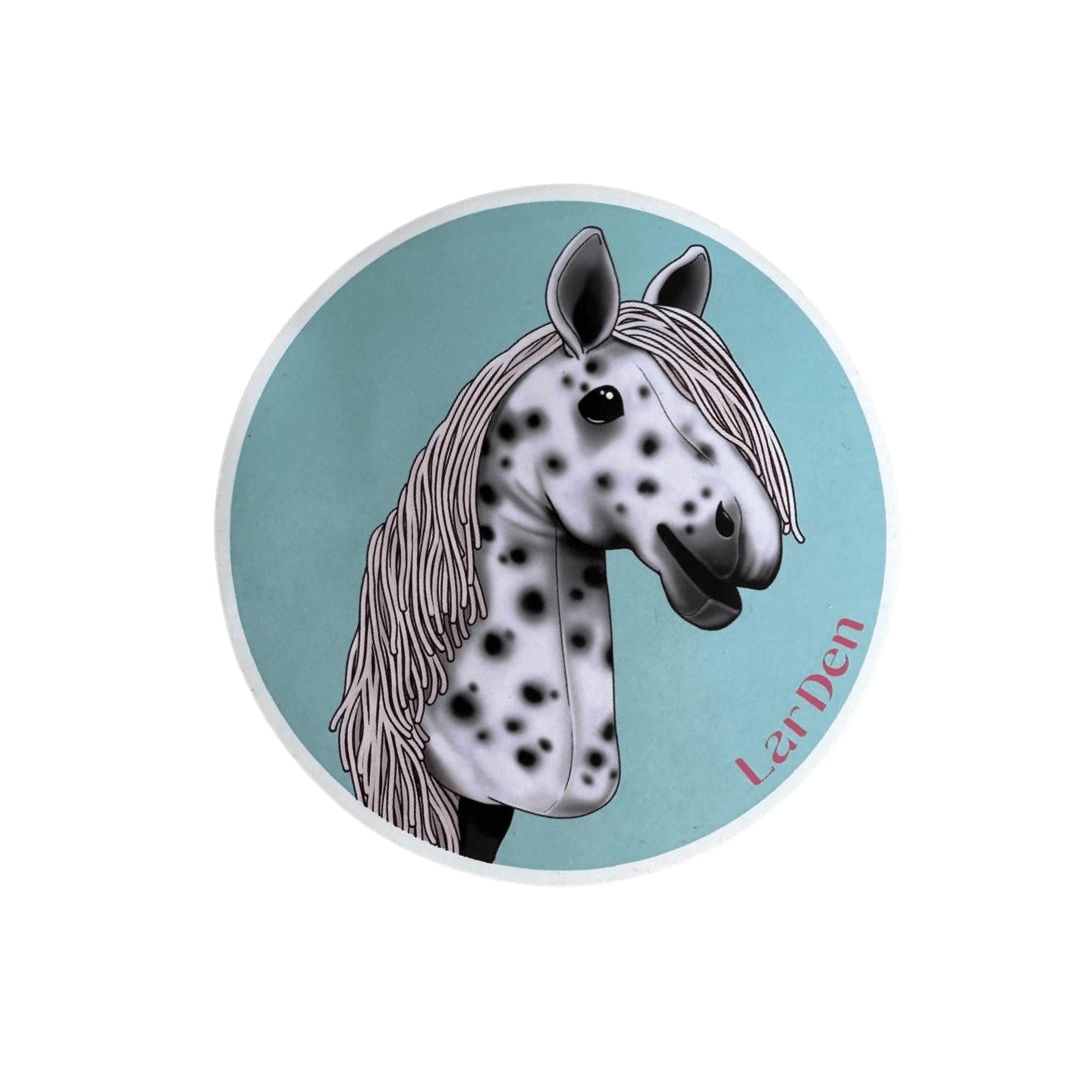 Sticker with a white Hobby Horse covered in black spots, with a grey mane, on a light turquoise circle