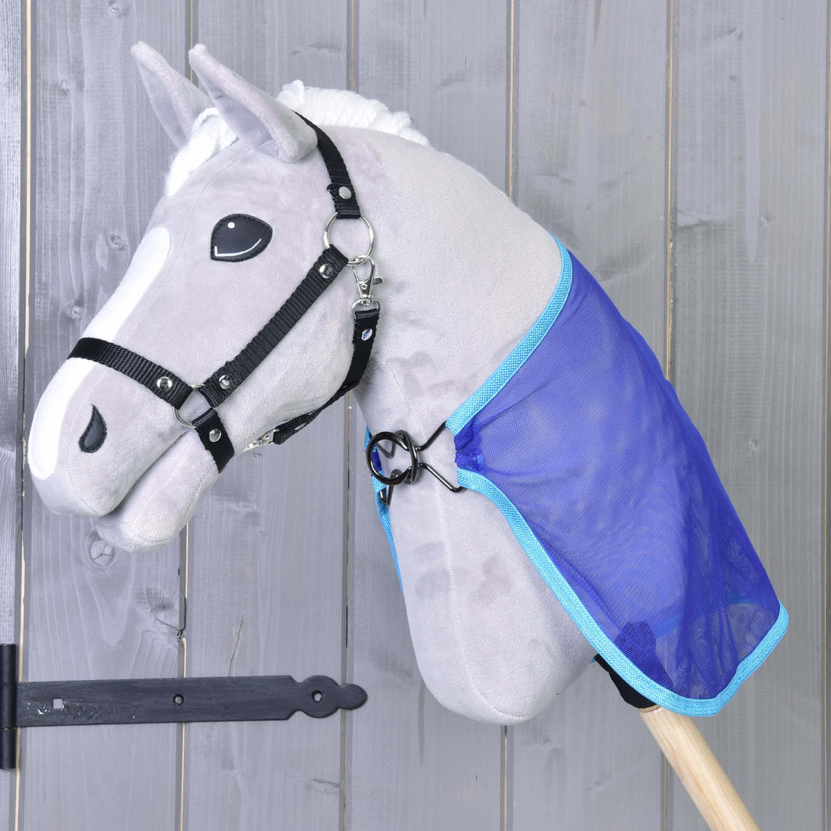 Grey plush Hobby Horse in a black halter wearing the blue mesh Fly sheet, fastened at the chest with a metal ring