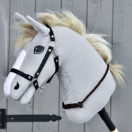 Light grey Hobby Horse with a cream mane and black halter wearing the Cordeo Chocolate low around its neck
