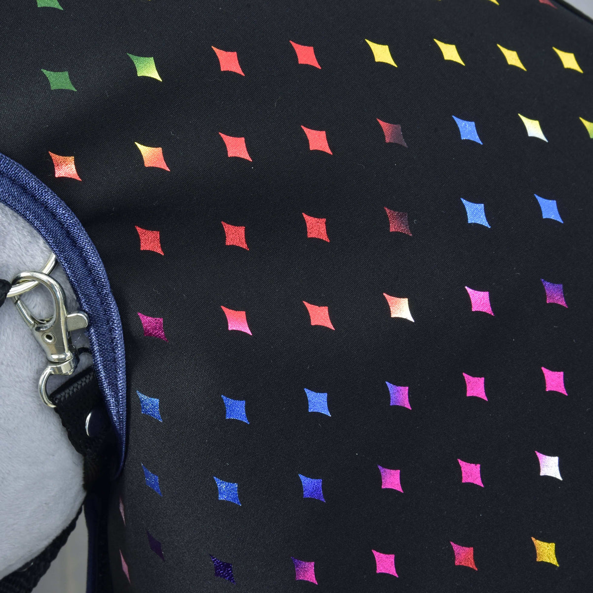 Close-up of the Raincoat Sparkling Queen: shiny rainbow-coloured diamonds on black fabric, navy binding and a halter clip