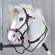 Light grey Hobby Horse wearing the Rope set York: dark brown knotted rope halter and reins with burgundy and pink accents
