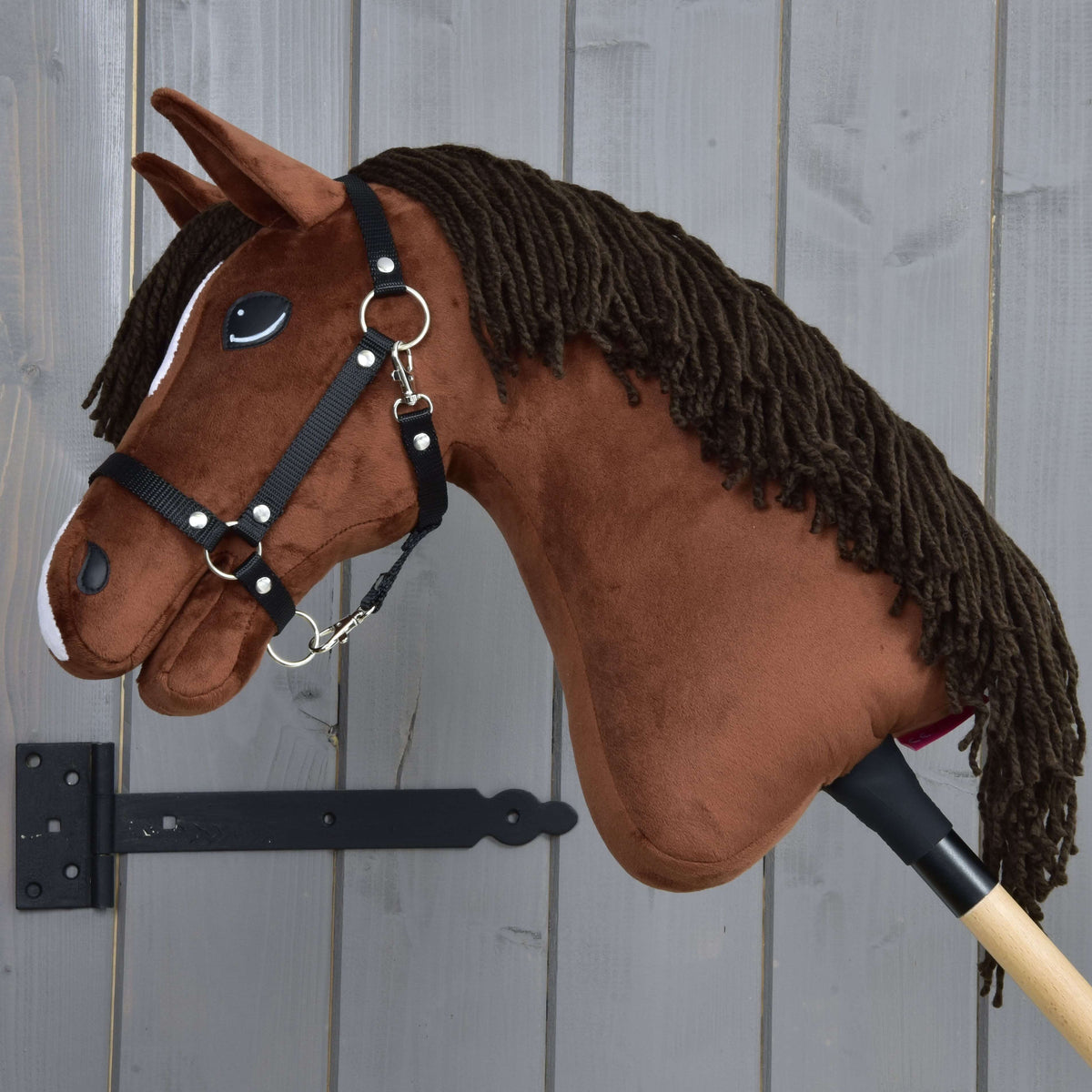 Hobby Horse konj Rocky v levem profilu z dolgo temno rjavo grivo iz preje čez kostanjevo rjavi vrat in črno oglavko