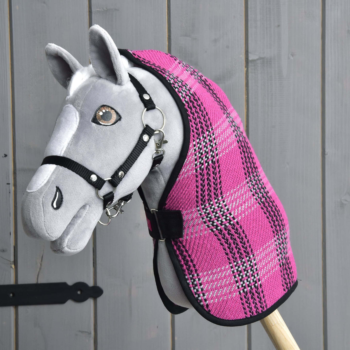 Grey Hobby Horse with brown eyes and a black halter wearing the Stable Blanket Pink in pink, black and grey plaid