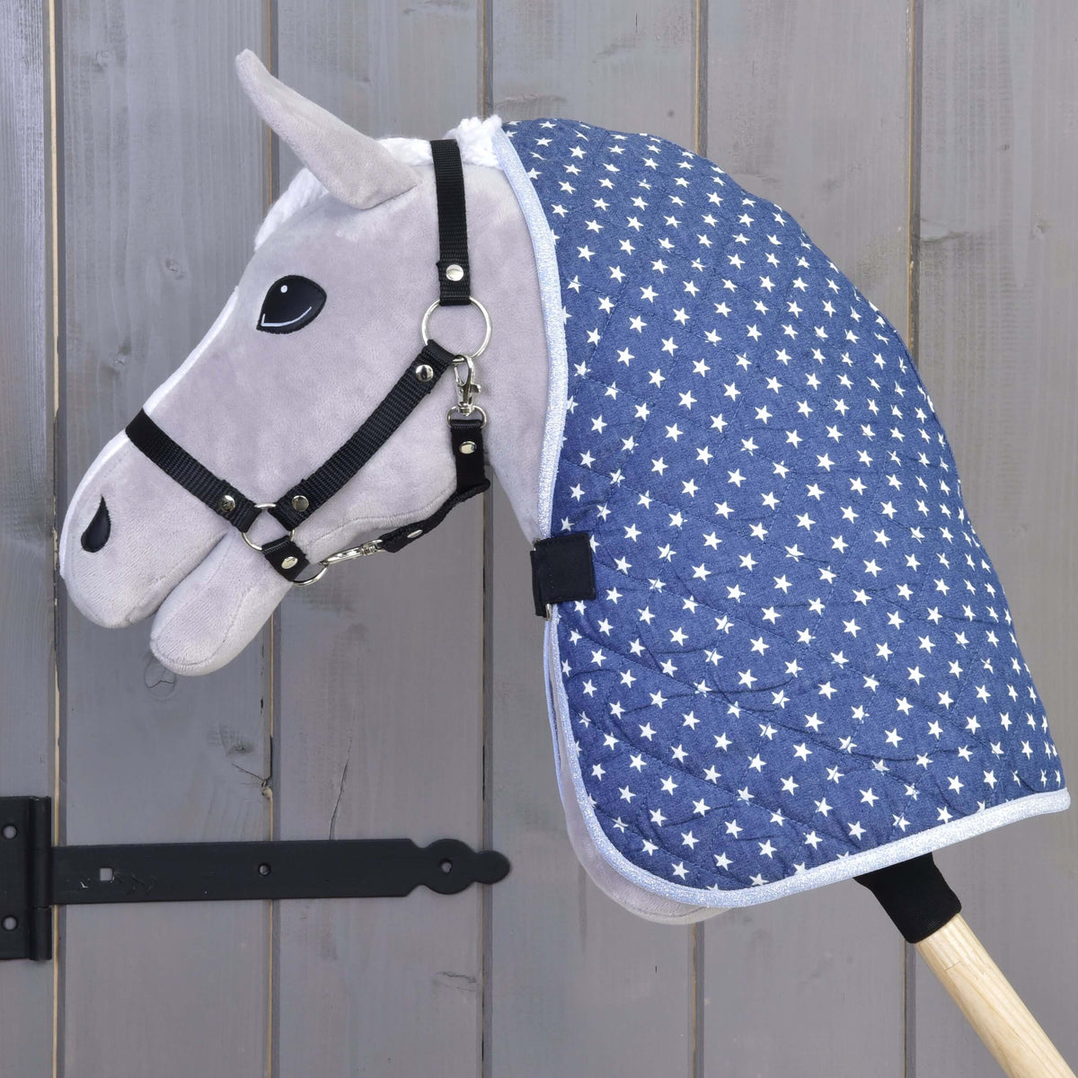 Side view of a grey Hobby Horse in the Stable Blanket Star, white stars on navy quilting reaching down the neck to the stick