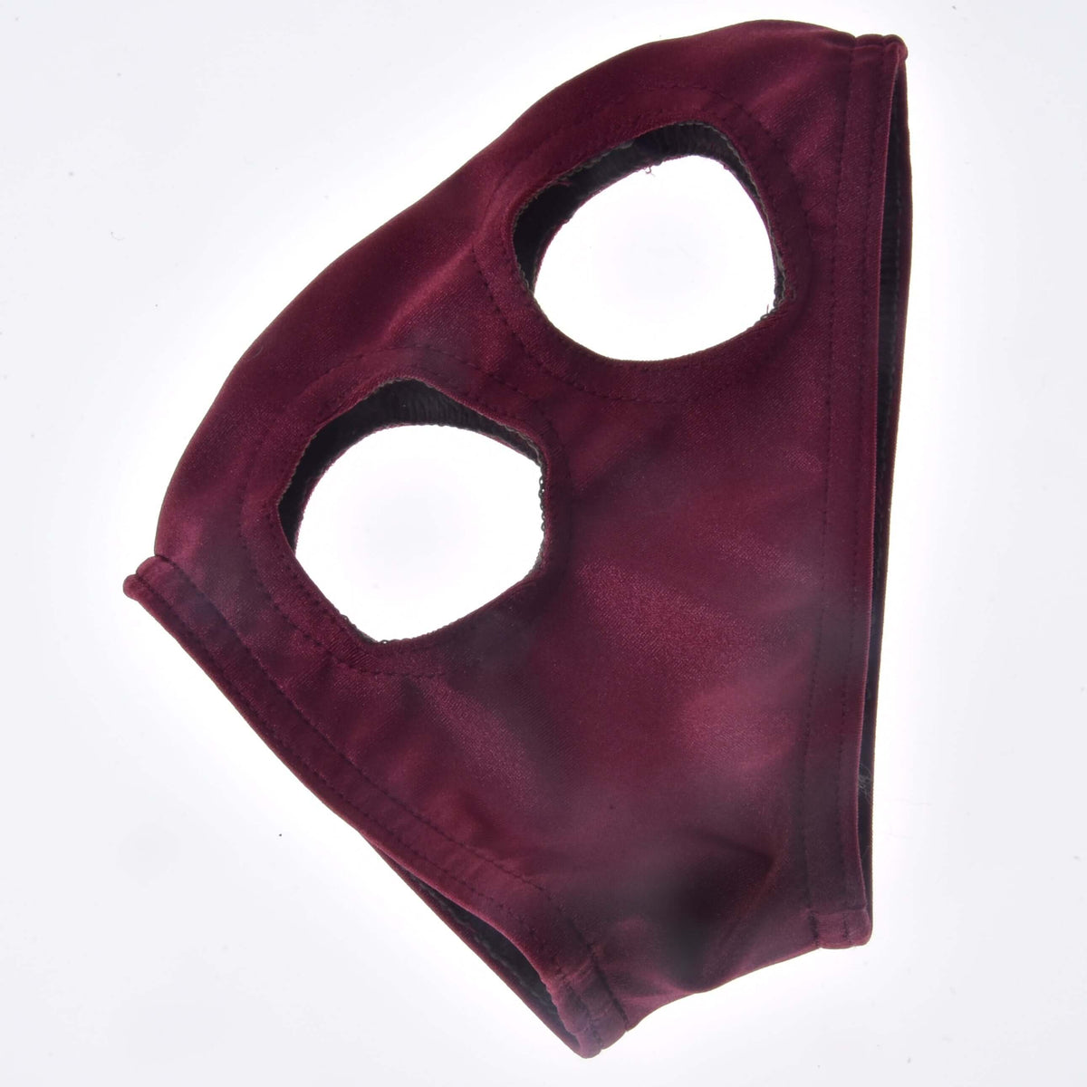 Horse Mask without Ears Velvet for a Hobby Horse, laid flat on white: soft burgundy fabric with two round eye openings