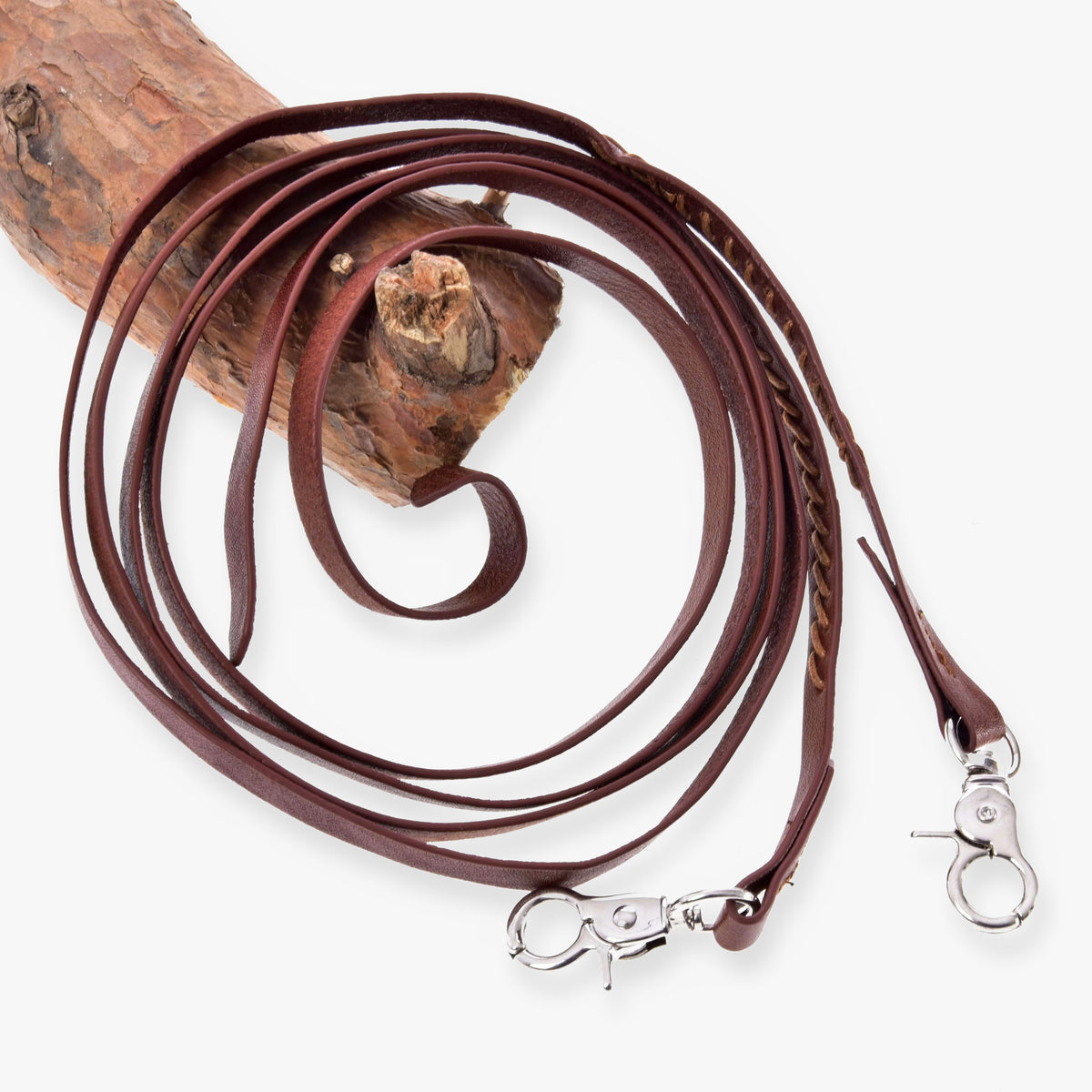 Hobby Horse Split Western Reins Dark Brown by LarDen with stitched detail and two silver snap hooks, coiled over a branch
