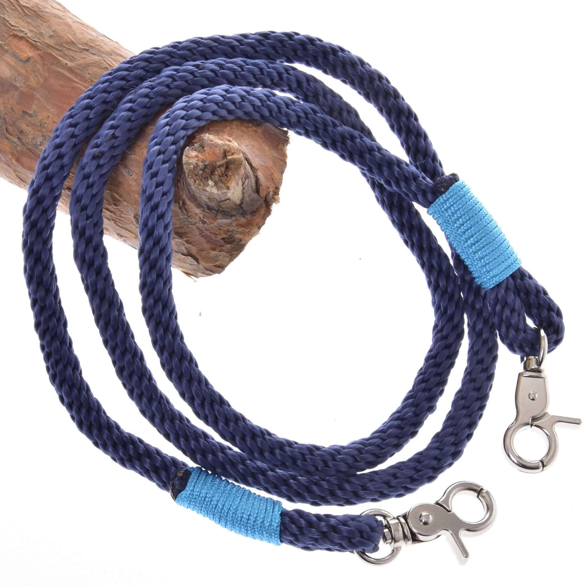 Navy braided rope reins for Hobby Horse with light blue wraps and two silver snap hooks, over a branch